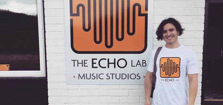 Rapper Elliot Stradling stands outside The Echo Lab music studios